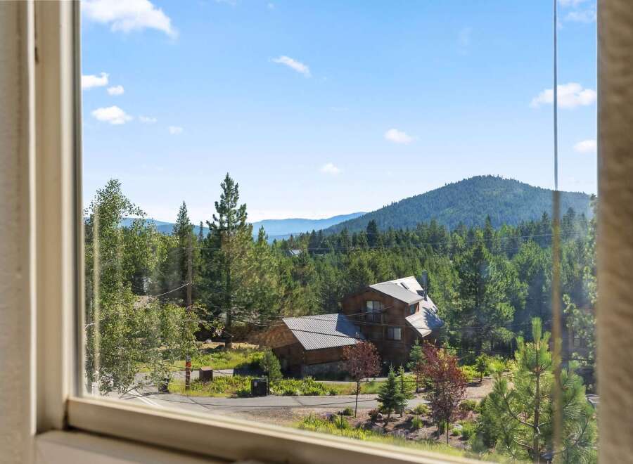 Experience serene mountain living with this stunning property nestled amidst lush evergreen forests.
