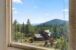 Experience serene mountain living with this stunning property nestled amidst lush evergreen forests.
