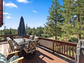 Enjoy breathtaking mountain views from this spacious deck, perfect for outdoor dining and entertaining.
