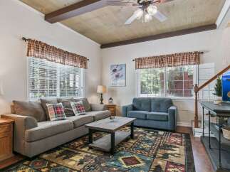 Step into this cozy living room featuring a comfortable gray sofa and a plush blue loveseat, perfect for relaxing after a day of adventure.