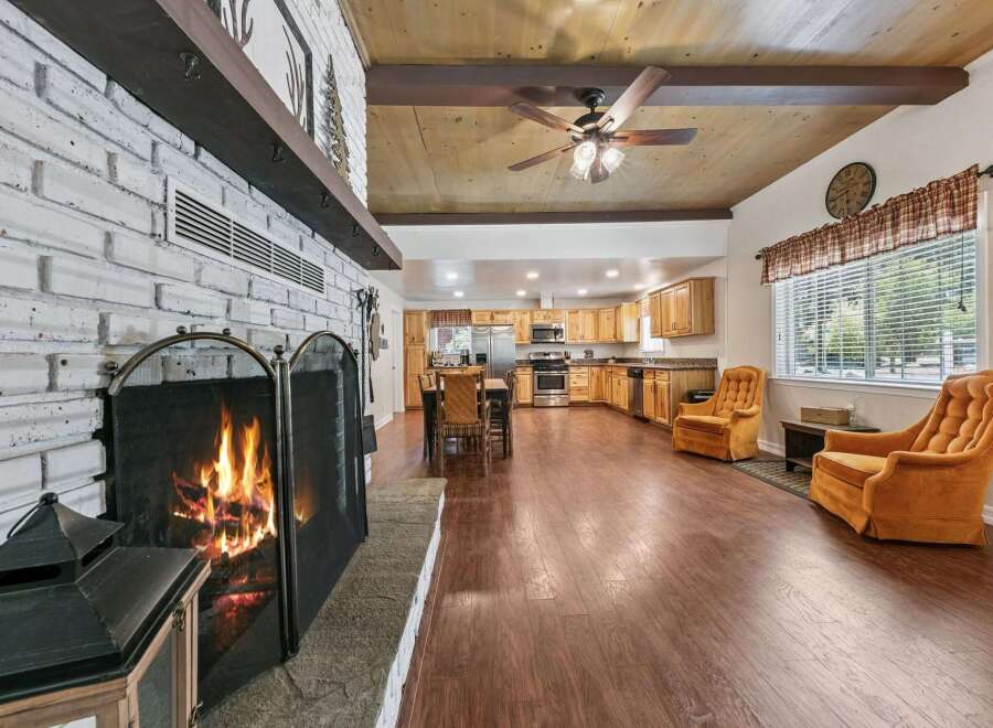 Cozy up by the crackling fireplace in this spacious open-concept living area, perfect for gatherings.