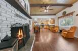 Cozy up by the crackling fireplace in this spacious open-concept living area, perfect for gatherings.