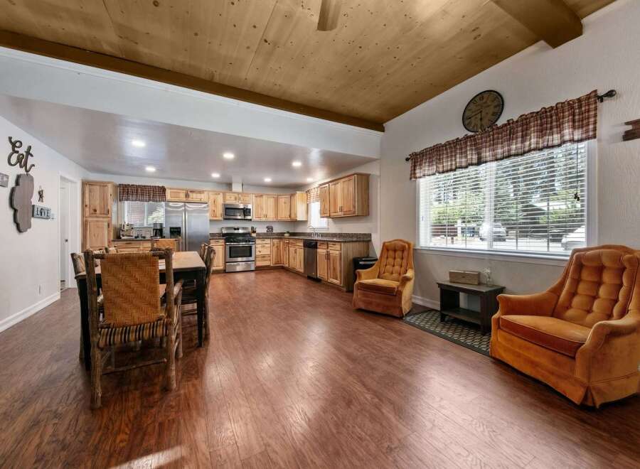 Experience rustic charm in this spacious open-concept kitchen and dining area, perfect for gatherings.