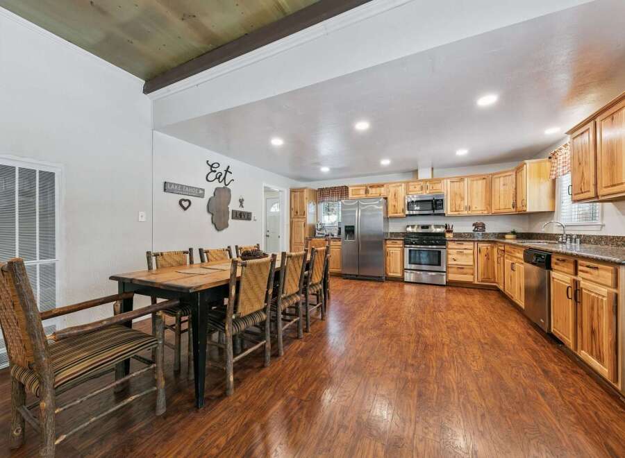 Experience rustic charm in this spacious kitchen and dining area, perfect for gatherings.