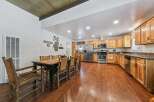 Experience rustic charm in this spacious kitchen and dining area, perfect for gatherings.