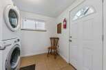 This laundry room features a stacked washer and dryer for space efficiency.
