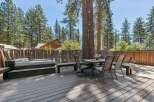 Enjoy outdoor living with this spacious deck featuring a relaxing hot tub and a dining area perfect for al fresco meals.