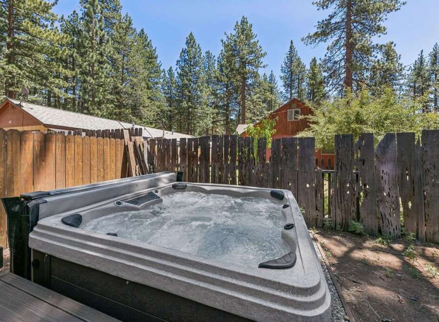 Relax and unwind in this luxurious hot tub, perfect for enjoying the serene mountain surroundings.