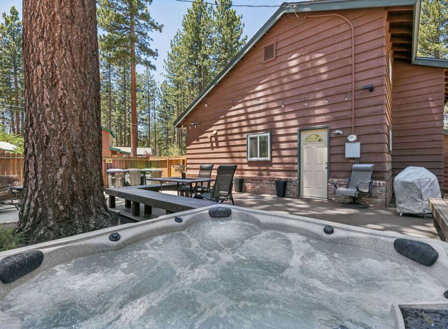 Relax and unwind in this inviting backyard oasis, complete with a bubbling hot tub perfect for soaking under the stars.