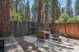 Enjoy cozy evenings in this charming backyard oasis, complete with a fire pit and comfortable seating.