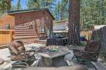 Enjoy outdoor living at its finest with this inviting backyard oasis, featuring a cozy fire pit perfect for gathering with loved ones.