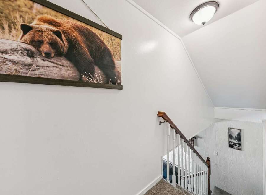 This home features a striking wall art of a bear resting on a log, adding a touch of wilderness to the interior.