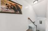This home features a striking wall art of a bear resting on a log, adding a touch of wilderness to the interior.
