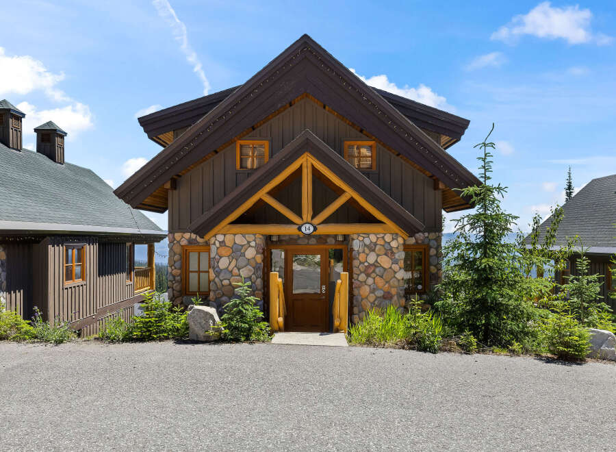 Experience rustic charm in this mountain-style home featuring a stone and wood exterior.
