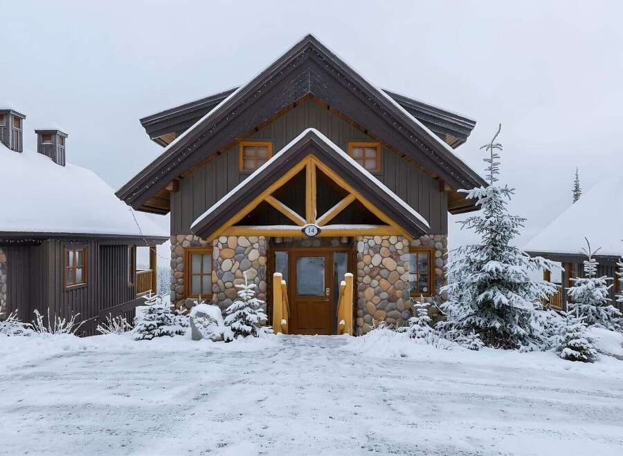 Experience the charm of this mountain retreat, featuring a rustic stone and wood facade perfect for a snowy landscape.