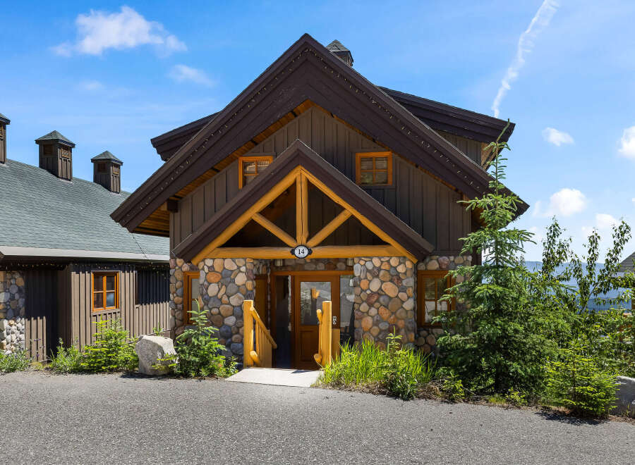 Experience rustic charm in this mountain cabin featuring a unique stone facade and warm wooden accents.