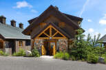 Experience rustic charm in this mountain cabin featuring a unique stone facade and warm wooden accents.