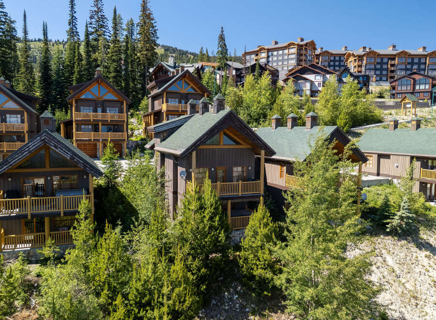 Experience luxury mountain living in this stunning ski-in/ski-out property, featuring a collection of exquisite chalets and condominiums nestled amidst towering evergreen trees.