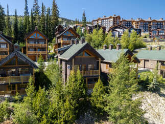 Experience luxury mountain living in this stunning ski-in/ski-out property, featuring a collection of exquisite chalets and condominiums nestled amidst towering evergreen trees.