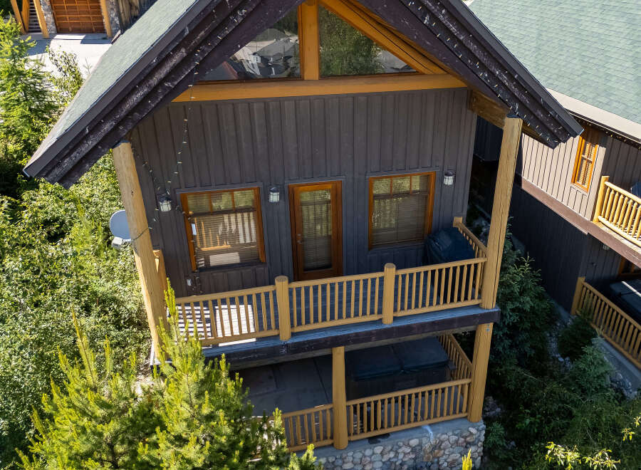 Experience the ultimate mountain retreat in this charming log cabin, featuring a spacious deck with a grill and a relaxing hot tub on the lower level.