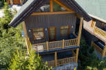 Experience the ultimate mountain retreat in this charming log cabin, featuring a spacious deck with a grill and a relaxing hot tub on the lower level.
