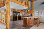 Experience rustic charm in this spacious kitchen featuring warm wood cabinetry and a large island with granite countertops, perfect for entertaining.