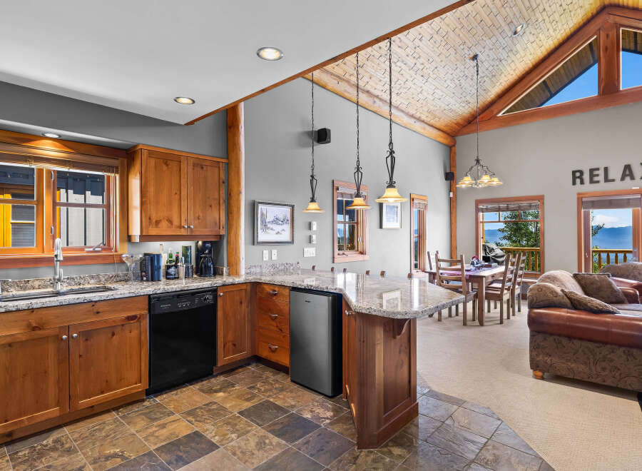 Experience breathtaking mountain and lake views from this stunning open-concept living space.