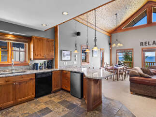 Experience breathtaking mountain and lake views from this stunning open-concept living space.