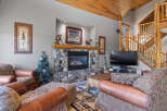Cozy up by the stone fireplace in this inviting living room, perfect for gathering with loved ones.