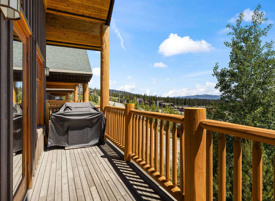 Enjoy breathtaking mountain views from this expansive wooden deck, perfect for outdoor entertaining.