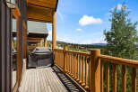 Enjoy breathtaking mountain views from this expansive wooden deck, perfect for outdoor entertaining.