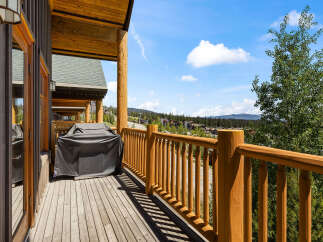 Enjoy breathtaking mountain views from this expansive wooden deck, perfect for outdoor entertaining.