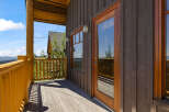 Enjoy breathtaking mountain views from this charming log cabin's expansive deck.