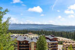 Experience breathtaking mountain views from this stunning property, nestled amidst a lush evergreen forest.