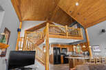 Experience rustic charm in this stunning log cabin-style home featuring a soaring wood-paneled vaulted ceiling and a beautiful loft overlooking the main living area.