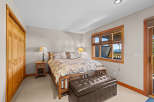 Experience ultimate comfort in this beautifully appointed bedroom, featuring a plush king-sized bed adorned with a nature-inspired comforter.