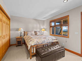Experience ultimate comfort in this beautifully appointed bedroom, featuring a plush king-sized bed adorned with a nature-inspired comforter.