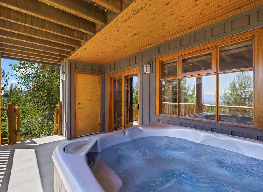 Relax and unwind in this luxurious outdoor hot tub, perfect for enjoying the stunning mountain views.