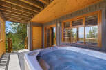 Relax and unwind in this luxurious outdoor hot tub, perfect for enjoying the stunning mountain views.