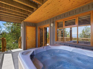 Relax and unwind in this luxurious outdoor hot tub, perfect for enjoying the stunning mountain views.