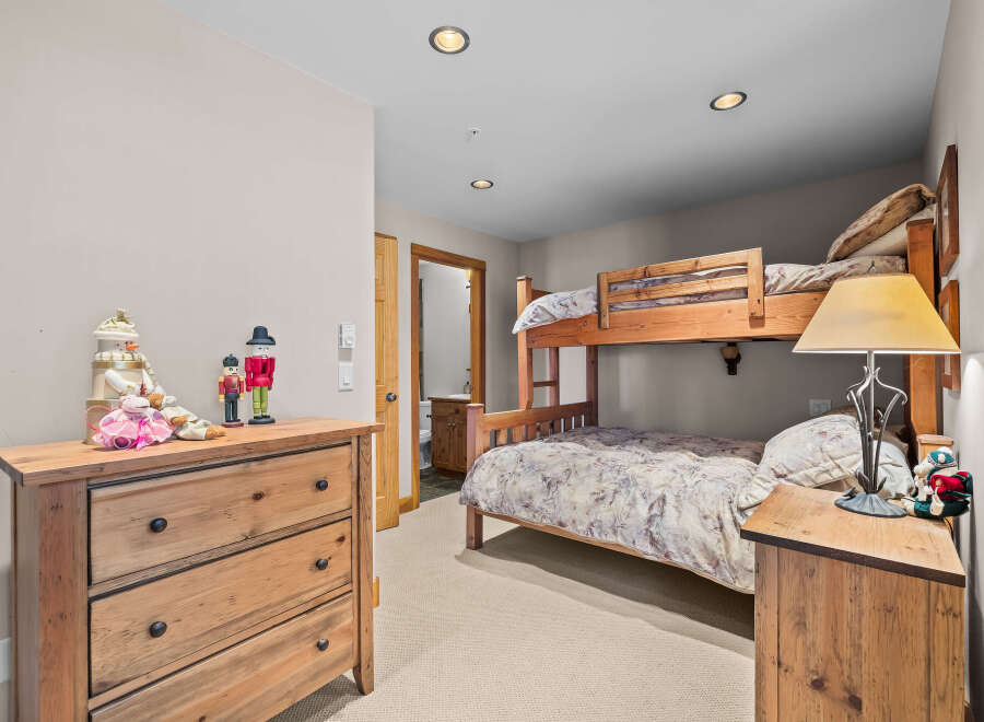 This charming bedroom features a space-saving bunk bed, perfect for families or guests.