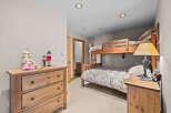 This charming bedroom features a space-saving bunk bed, perfect for families or guests.