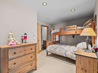 This charming bedroom features a space-saving bunk bed, perfect for families or guests.