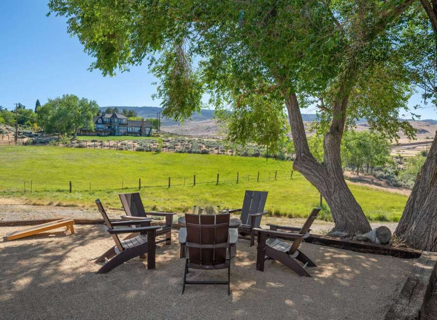 Enjoy the serene outdoor living space with a cozy fire pit area, perfect for gathering with friends and family.