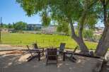 Enjoy the serene outdoor living space with a cozy fire pit area, perfect for gathering with friends and family.