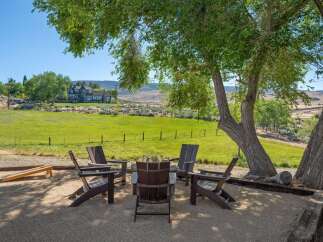Enjoy the serene outdoor living space with a cozy fire pit area, perfect for gathering with friends and family.