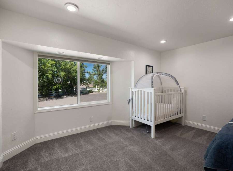 This charming nursery features a cozy white crib with a canopy, perfect for a little one's dreams.