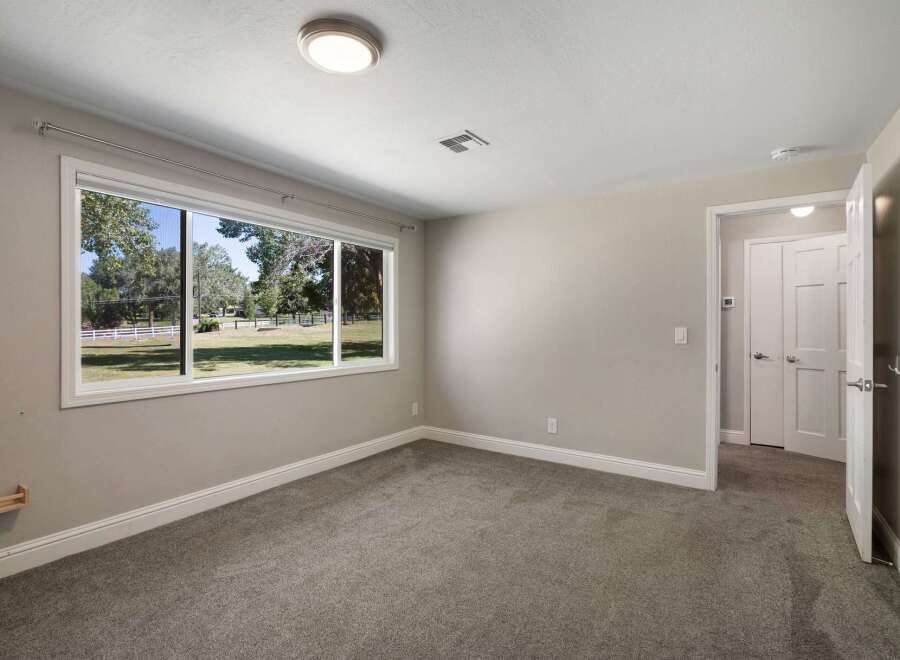 Experience comfortable living in this spacious room featuring a large picture window that floods the space with natural light and offers serene views of the outdoors.