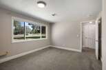 Experience comfortable living in this spacious room featuring a large picture window that floods the space with natural light and offers serene views of the outdoors.