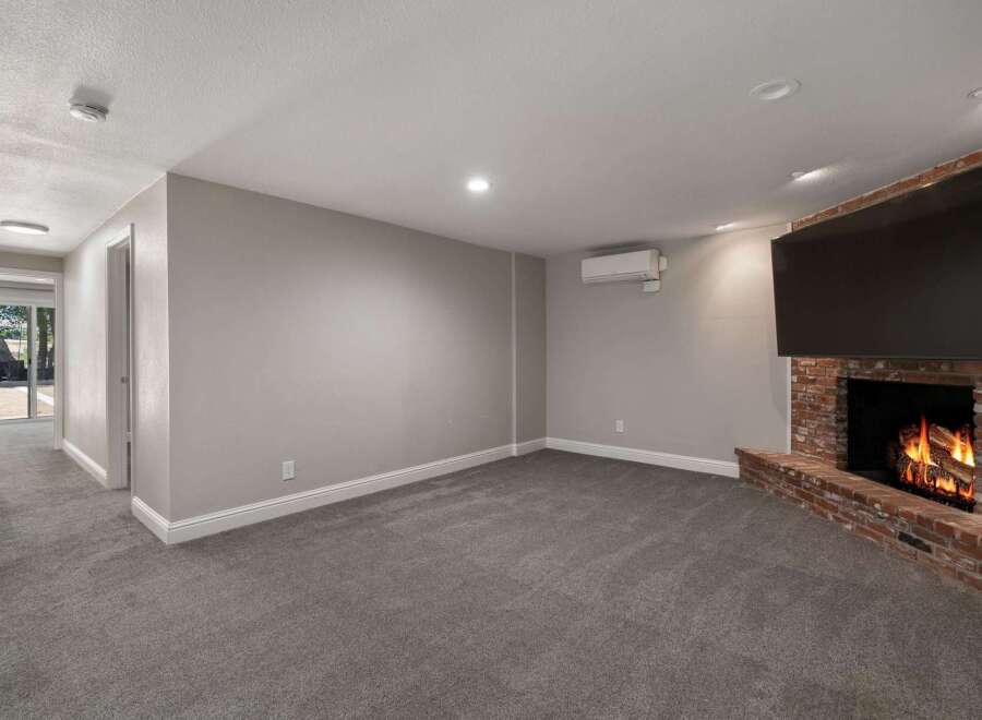 Cozy up by the brick fireplace in this inviting living space, complete with a large flat-screen TV for entertainment.
